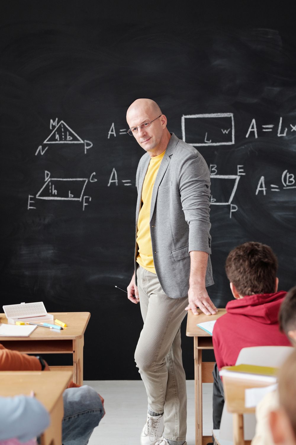 Parents and teacher discussing student progress at a table