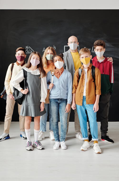 Free Teacher and Students Wearing Face Masks Stock Photo