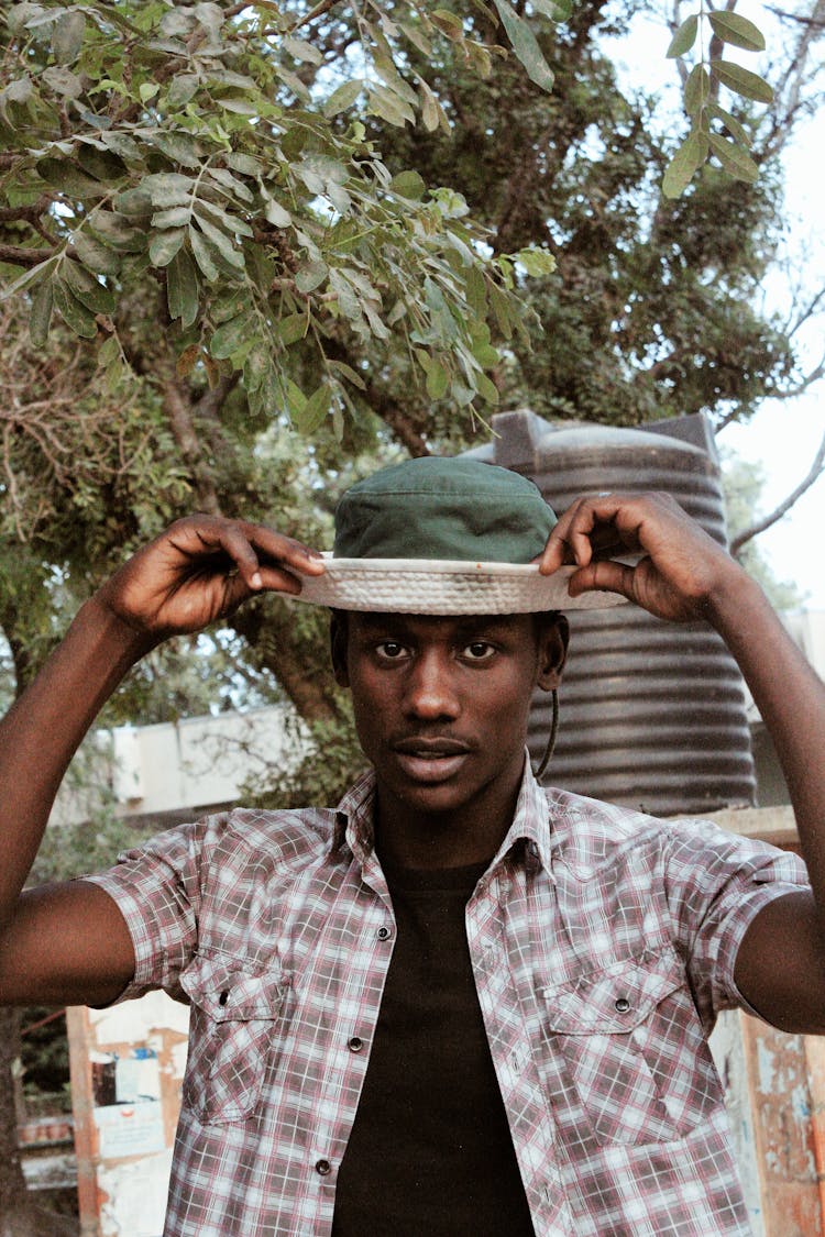 Stylish African Man Touching Panama Hat On Street