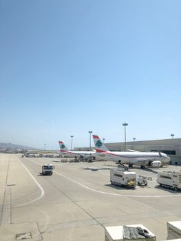 Airplanes on the runway at Beirut Airport under a clear blue sky, showcasing aviation.