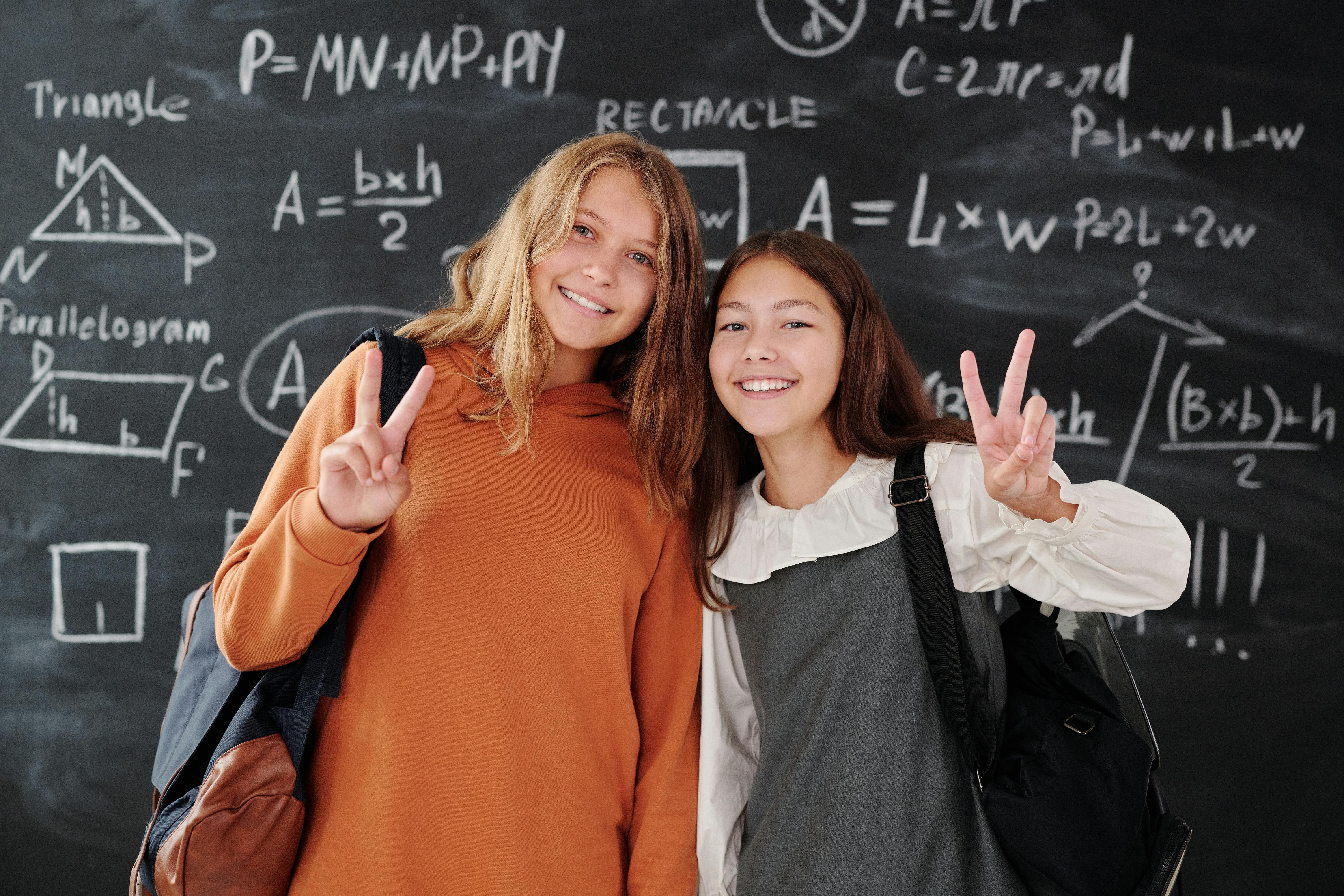 a two girls doing peace sign