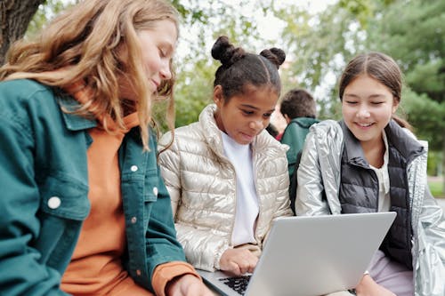 Free A Three Girls Looking the Laptop Together Stock Photo