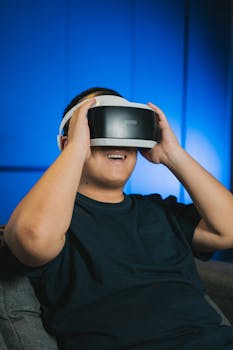 A man enthusiastically using a VR headset indoors, immersed in a virtual reality experience.