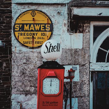 A weathered vintage Shell gas pump and sign in St Mawes, England.