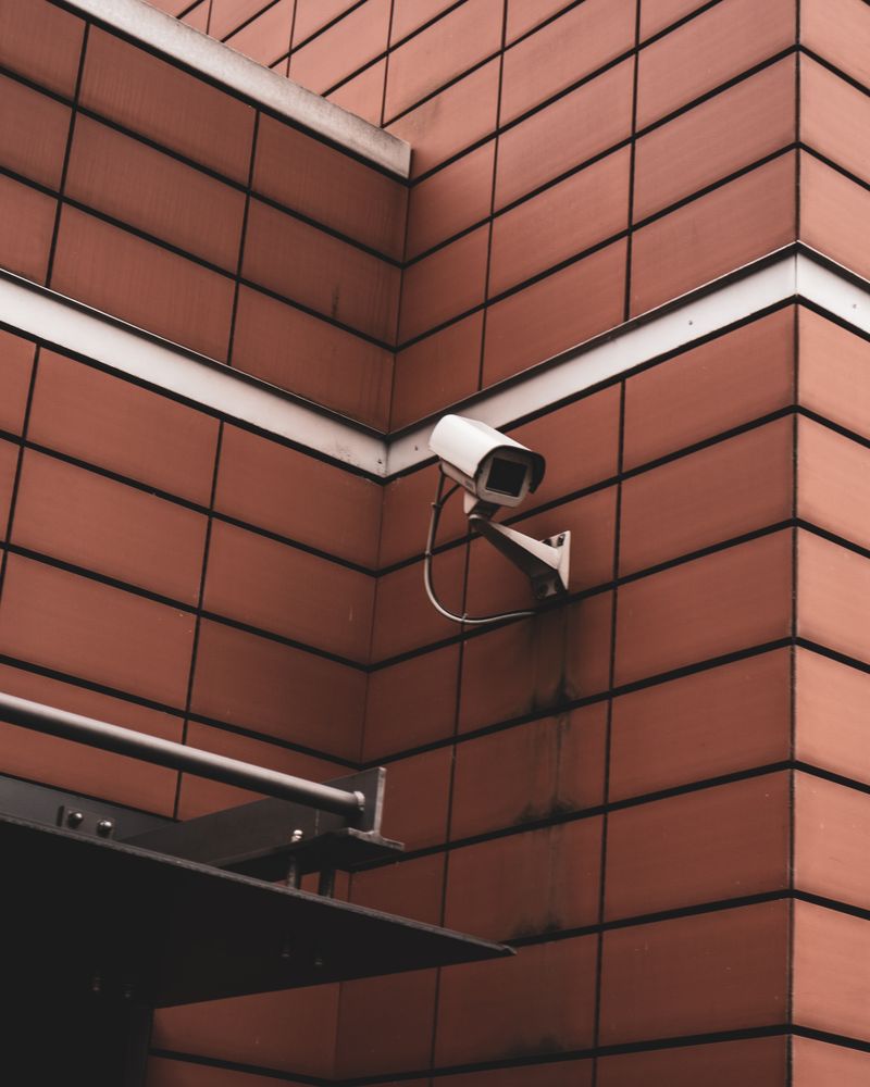 Surveillance camera mounted on exterior wall of a home
