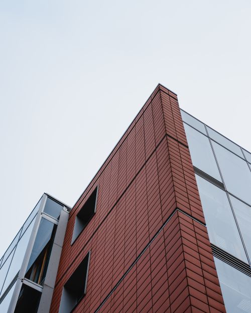 Free Low angle view of a modern building facade showcasing geometric patterns and contemporary design in Germany. Stock Photo