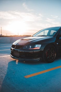 Modern vehicle with headlights and sport hood on asphalt parking lot under bright sunlight