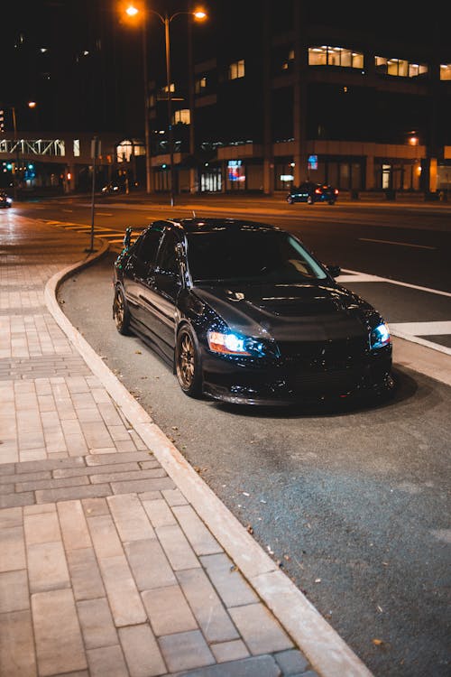 Modern car on street at night