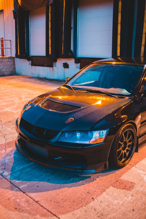 Free Contemporary automobile with sport design on stone street near building under bright lights Stock Photo