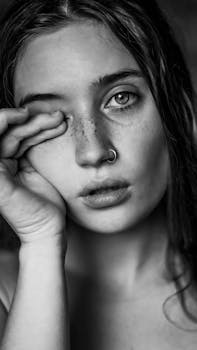 young sad female with freckles and piercing