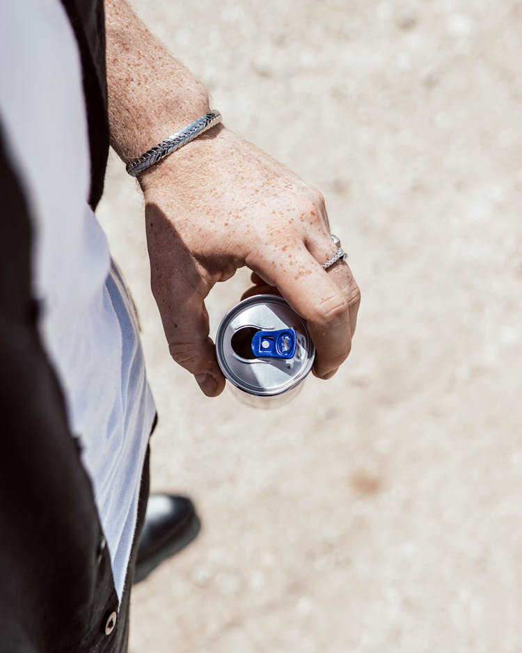 Person Holding A Can