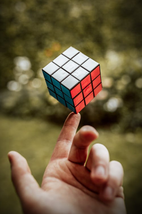 Person Balancing a Rubik's Cube