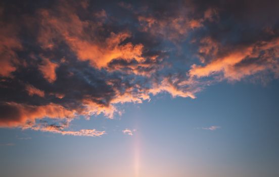 A vibrant sunset with dramatic clouds filling the sky, creating a stunning visual.