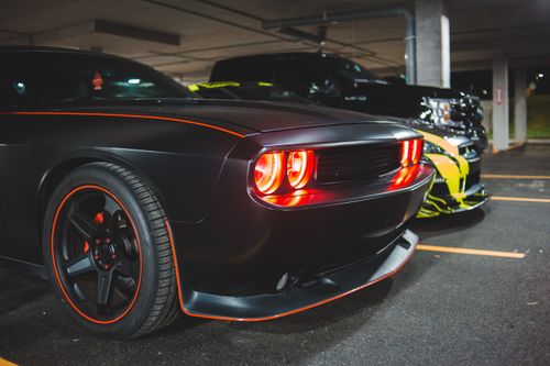 Free Luxury powerful sports cars with switched headlights parked on asphalt parking lot in garage Stock Photo