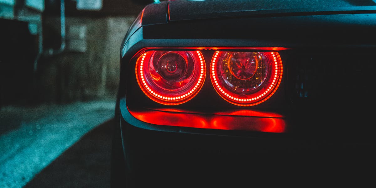 Auto body technician inspecting collision damage at Motolux in Vancouver WA