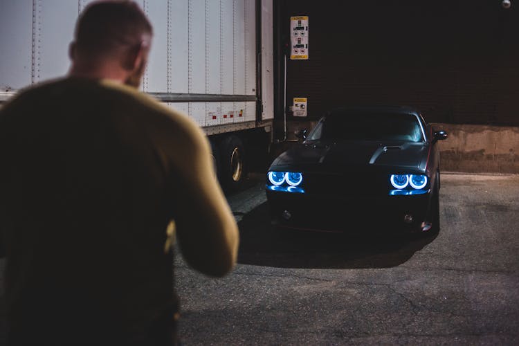 Anonymous Man On Parking Lot Near Car