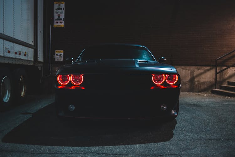 Black Car With Red Headlights In Night