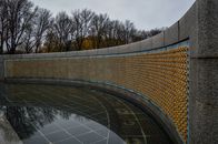 Golden stars on Freedom Wall at World War II Memorial located in in National Mall in Washington DC against gloomy sky