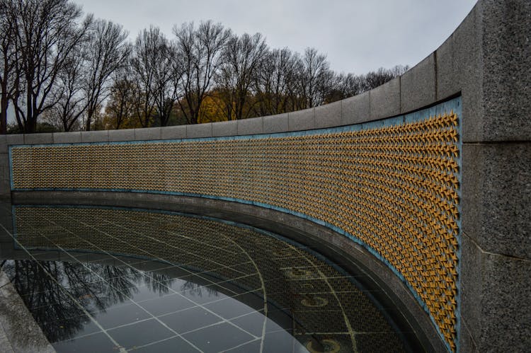 Memorial Wall Decorated With Golden Stars In Park On Rainy Day