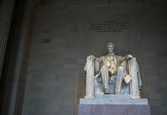 From below of marble statue of American president sitting on chair near wall with inscription located in Washington DC