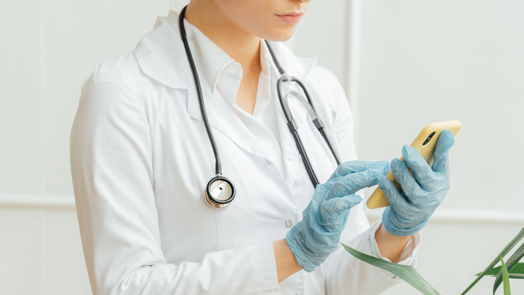 Healthcare professional using a phone or front-desk technology in a modern practice