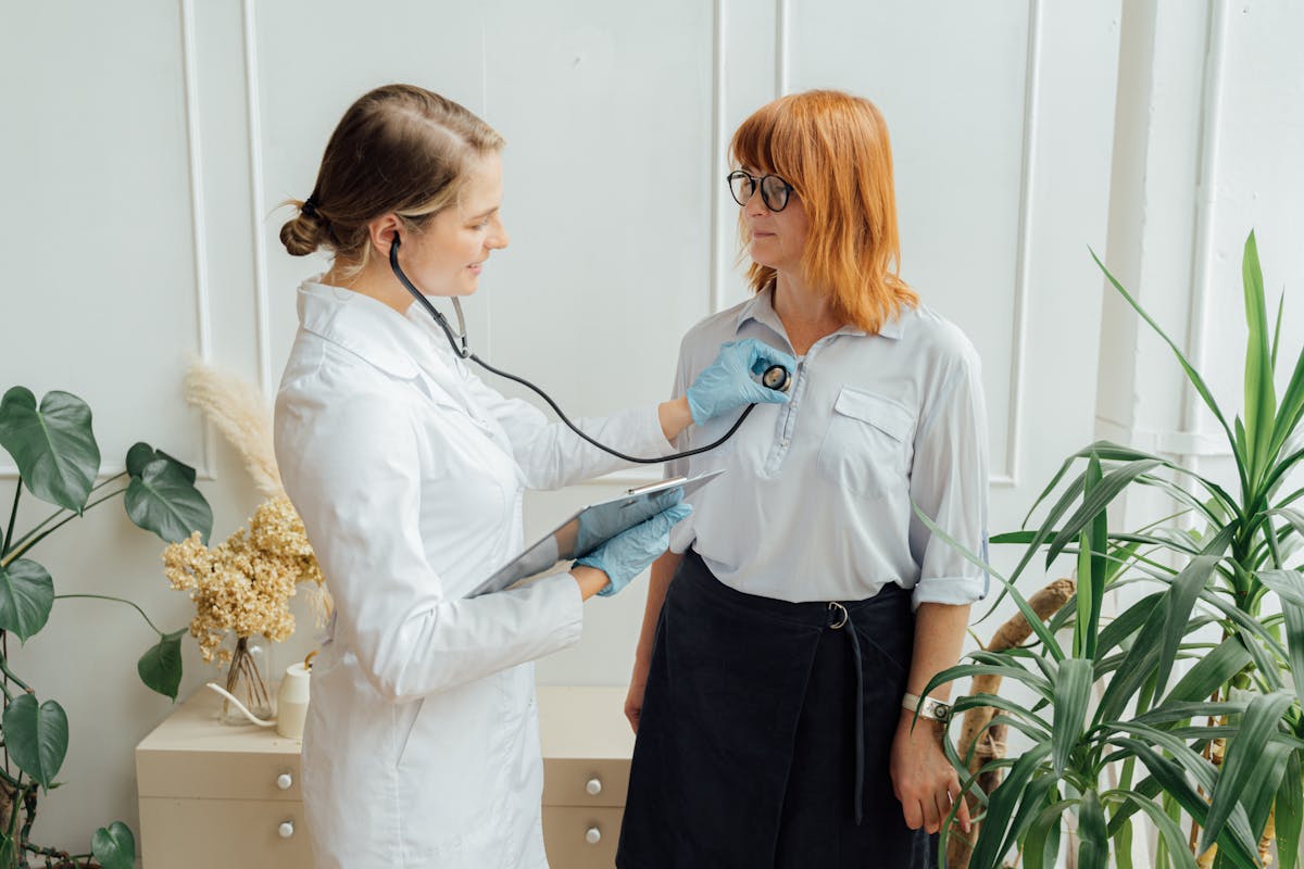 Cardiologist using stethoscope to check a patient heart during a bulk billed specialist consultation in Melbourne