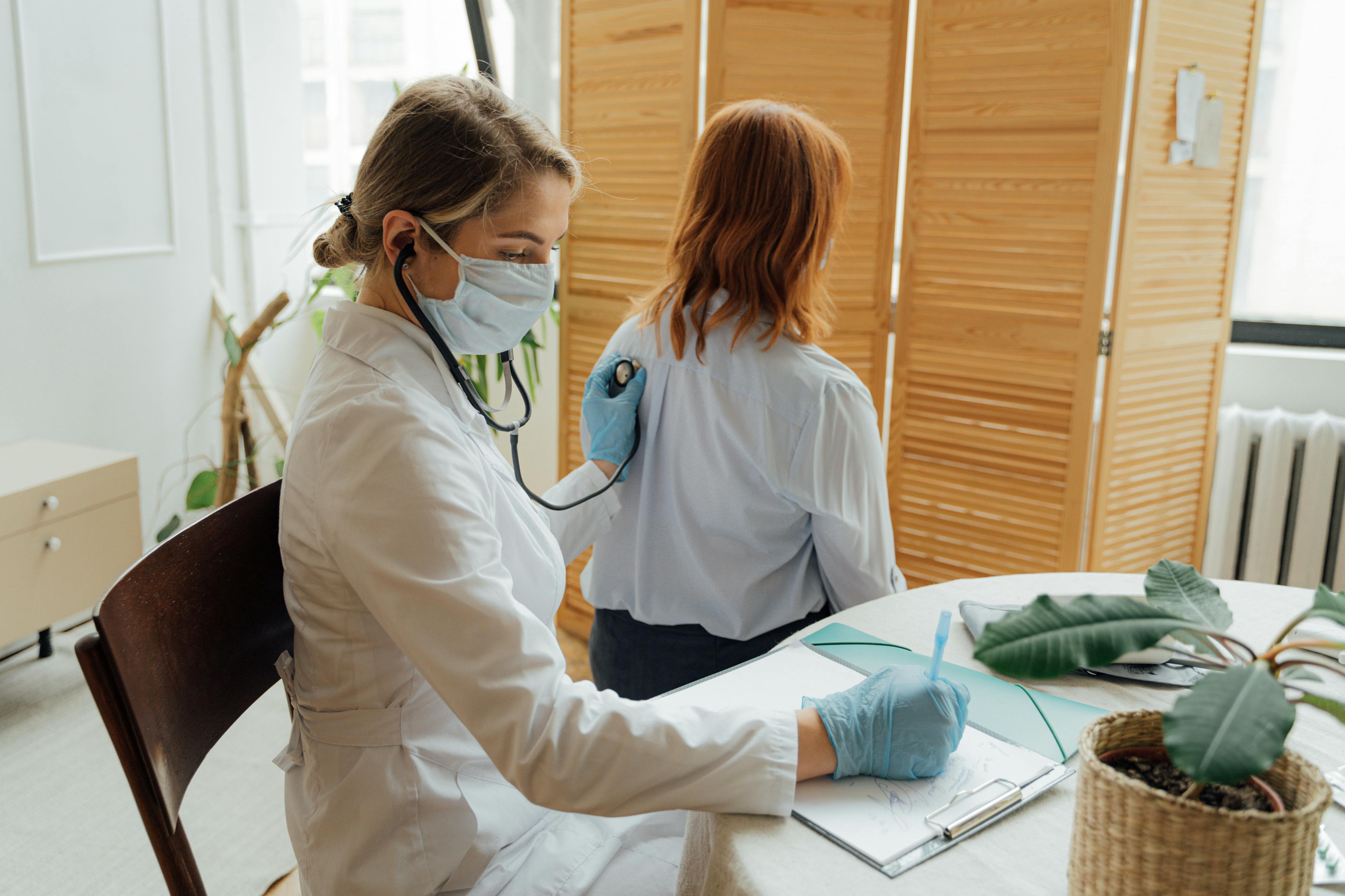 woman in white long sleeve shirt and blue and white face mask