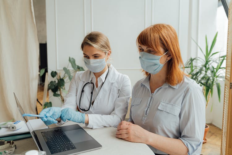 Doctor And Patient Looking At The Laptop Screen