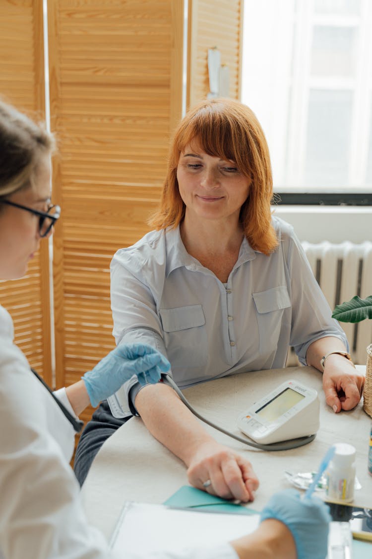 Checking The Blood Pressure Of A Woman