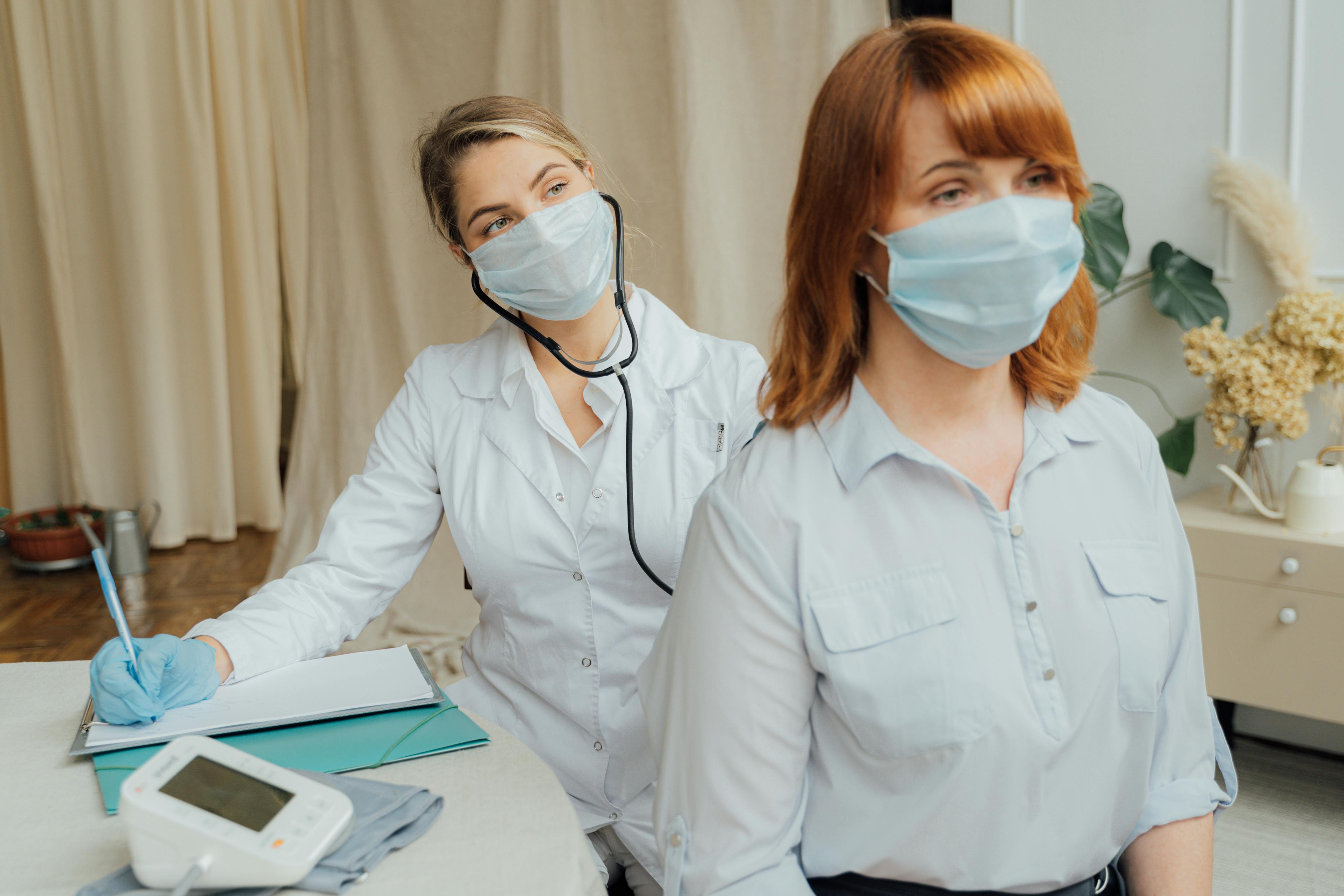 woman in white dress shirt wearing white face mask