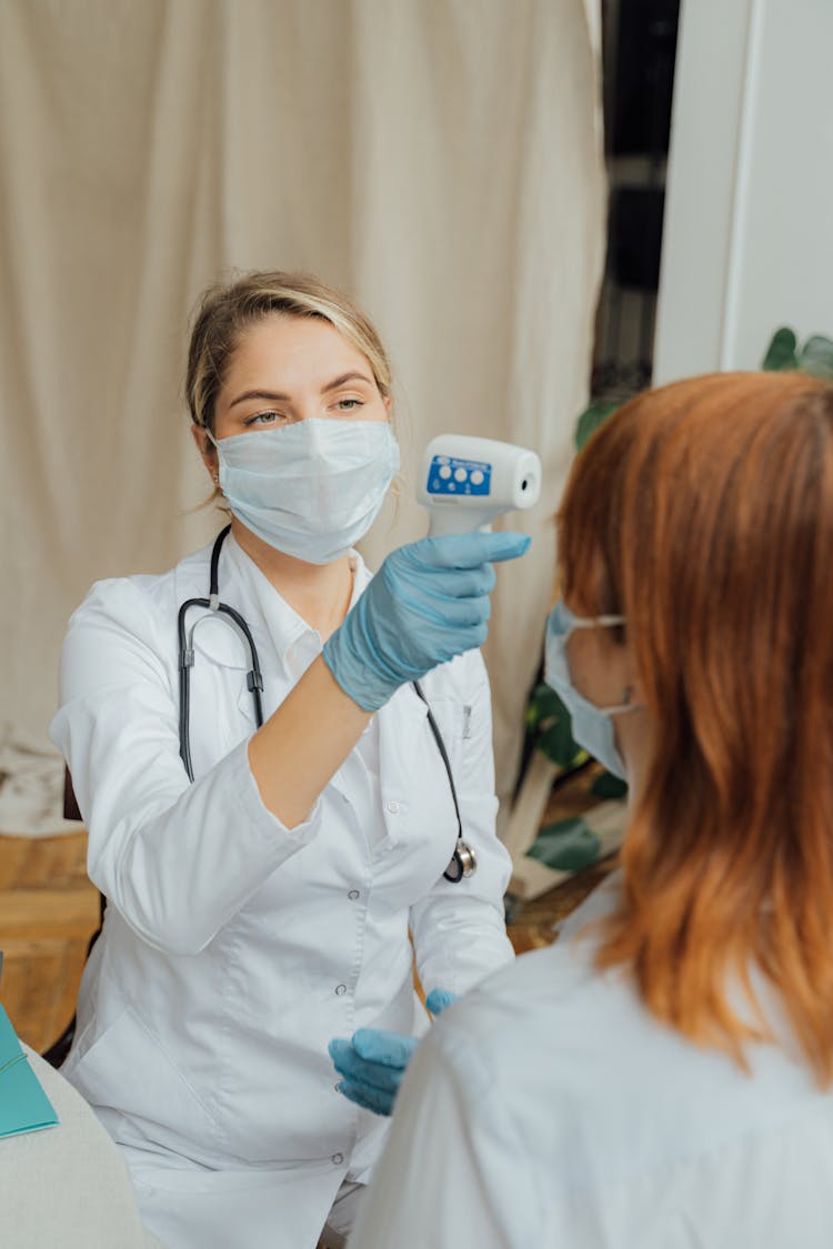 Doctor Checking The Temperature Of A Patient