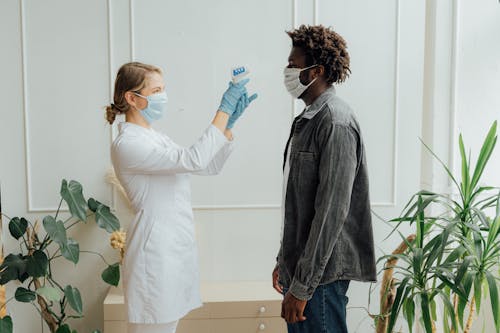 Doctor Checking the Temperature of a Man