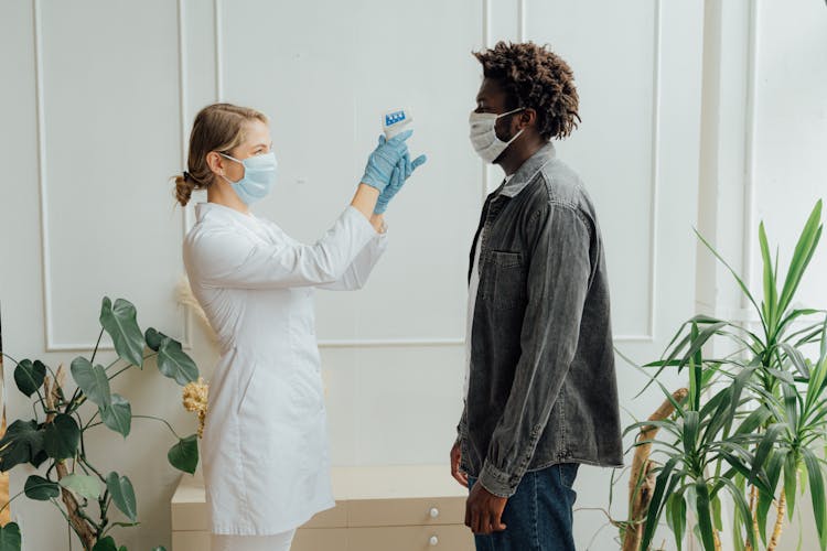 Doctor Checking The Temperature Of A Man