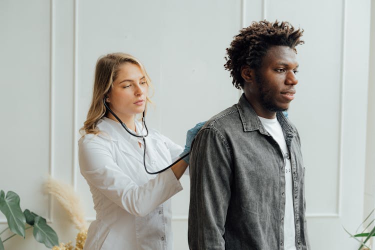 Doctor Checking The Back Of A Man