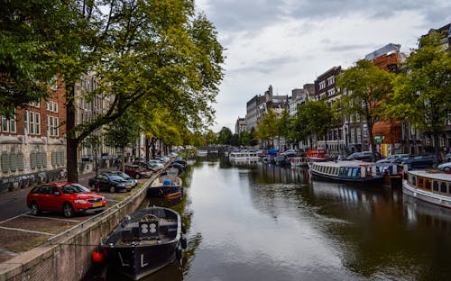 City historical district with moored boats on canal