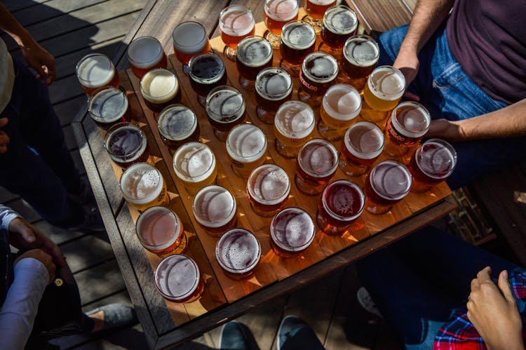 Unrecognizable People Tasting Different Varieties Of Beer In Cafe