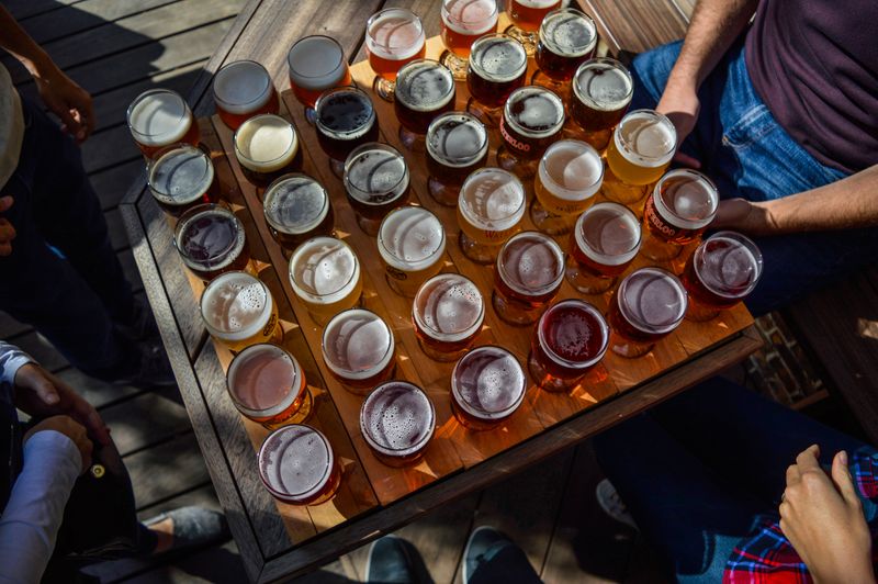 Friends sharing a craft beer flight around a table at Ironside Brewing Co.