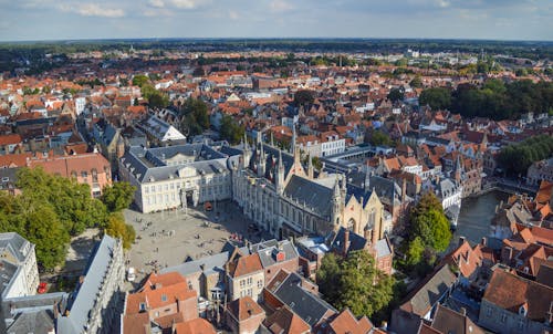 From above of historical Bruges City Hall located on Burg Square near canal and aged buildings on sunny day
