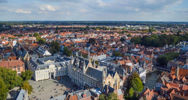 Explore the medieval architecture and canals of Bruges from this stunning aerial view.