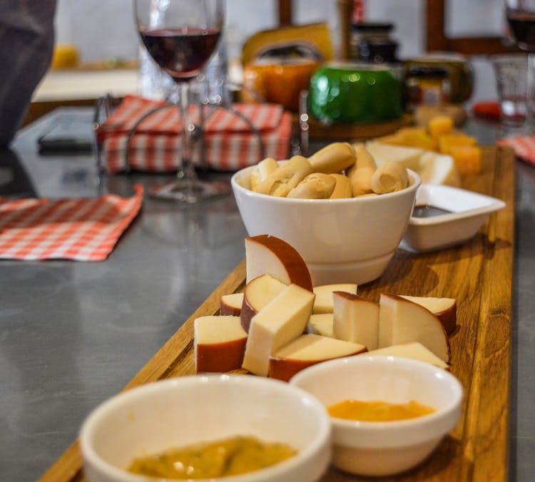 Sliced Cheese And Food On A Wooden Platter