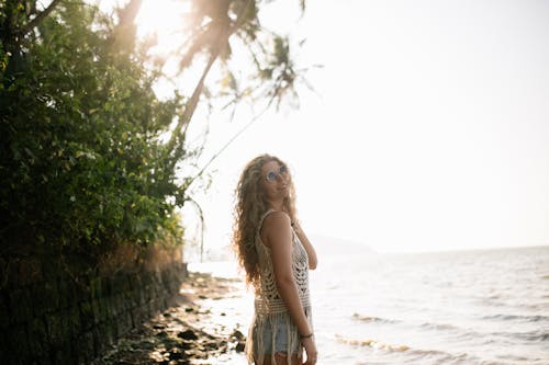 Free Happy Woman Standing on a Seashore  Stock Photo