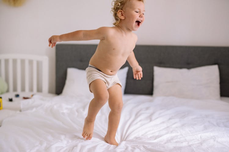 Baby Jumping On Bed