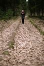 Woman Standing in Forest and Dry Leaves