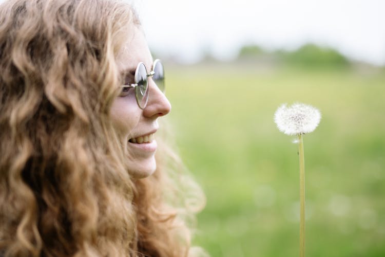 Smiling Woman And Dandelion