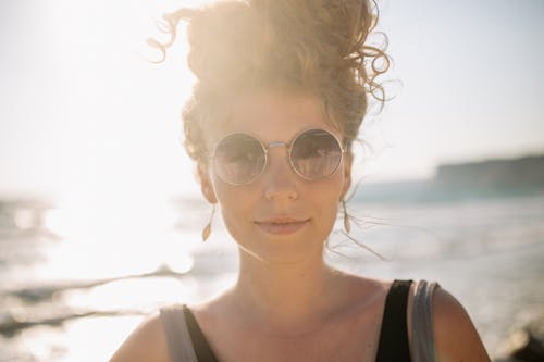 Woman in Tank Top Wearing Silver Framed Sunglasses