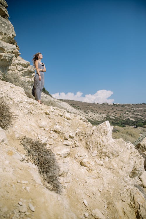 Woman Standing on Rocky Mountain