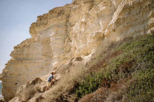 Man Climbing on Brown Rocky Mountain