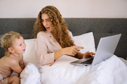 Free A Mother and Toddler Looking at a Laptop Stock Photo