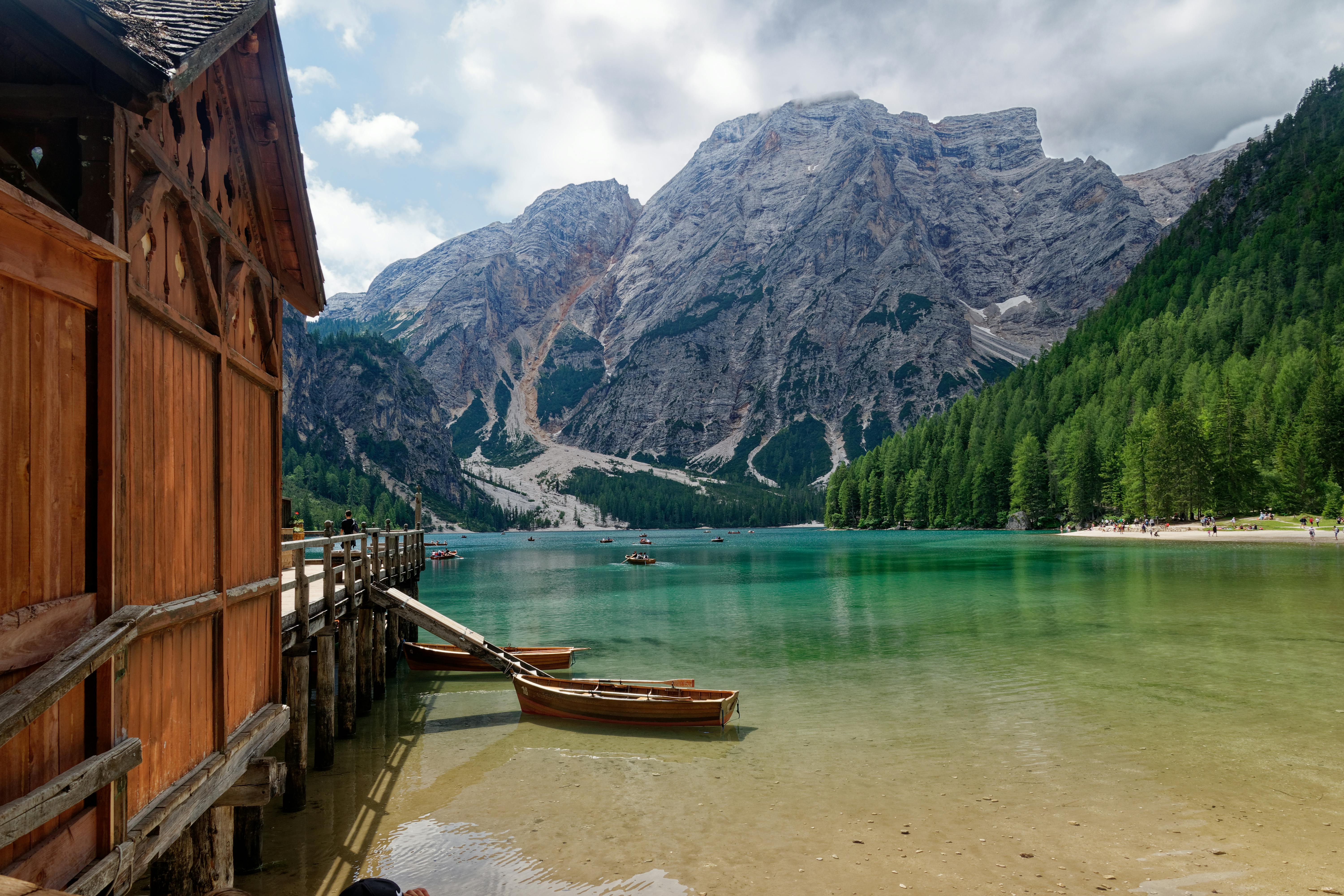 Wooden Houses on Water near Mountains · Free Stock Photo