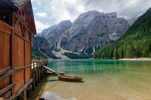 Free Wooden Houses on Water near Mountains Stock Photo